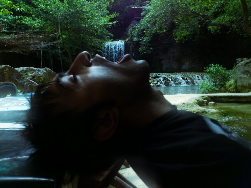 Man Lying Near Waterfall