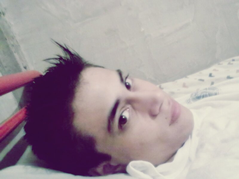 man lying on bed looking at camera