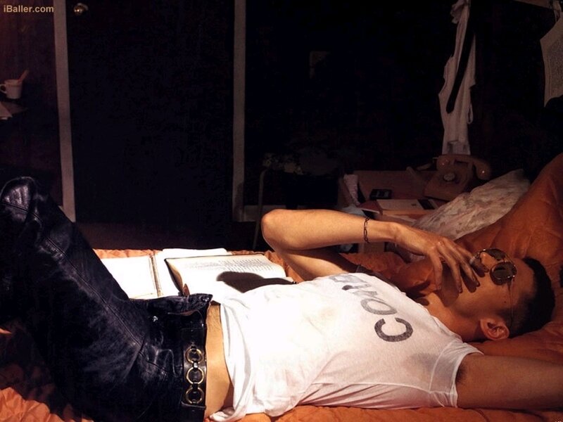 man lying on bed reading