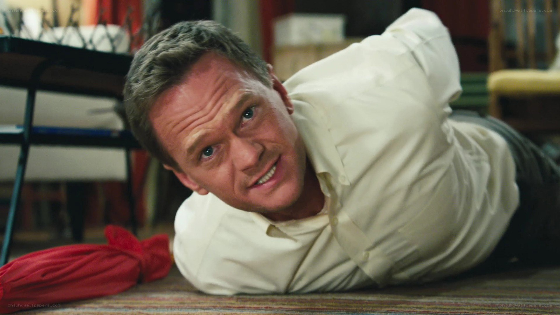 man lying on floor smiling