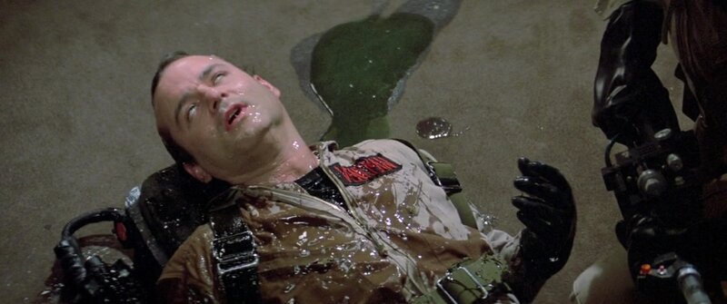 man lying on ground in wet suit