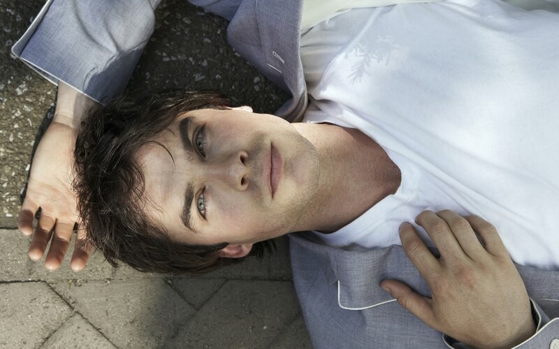 man lying on ground looking up