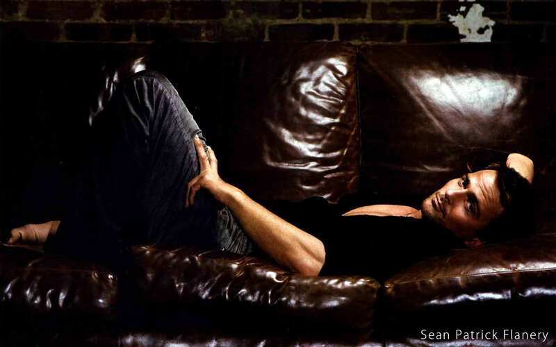 man lying on leather couch