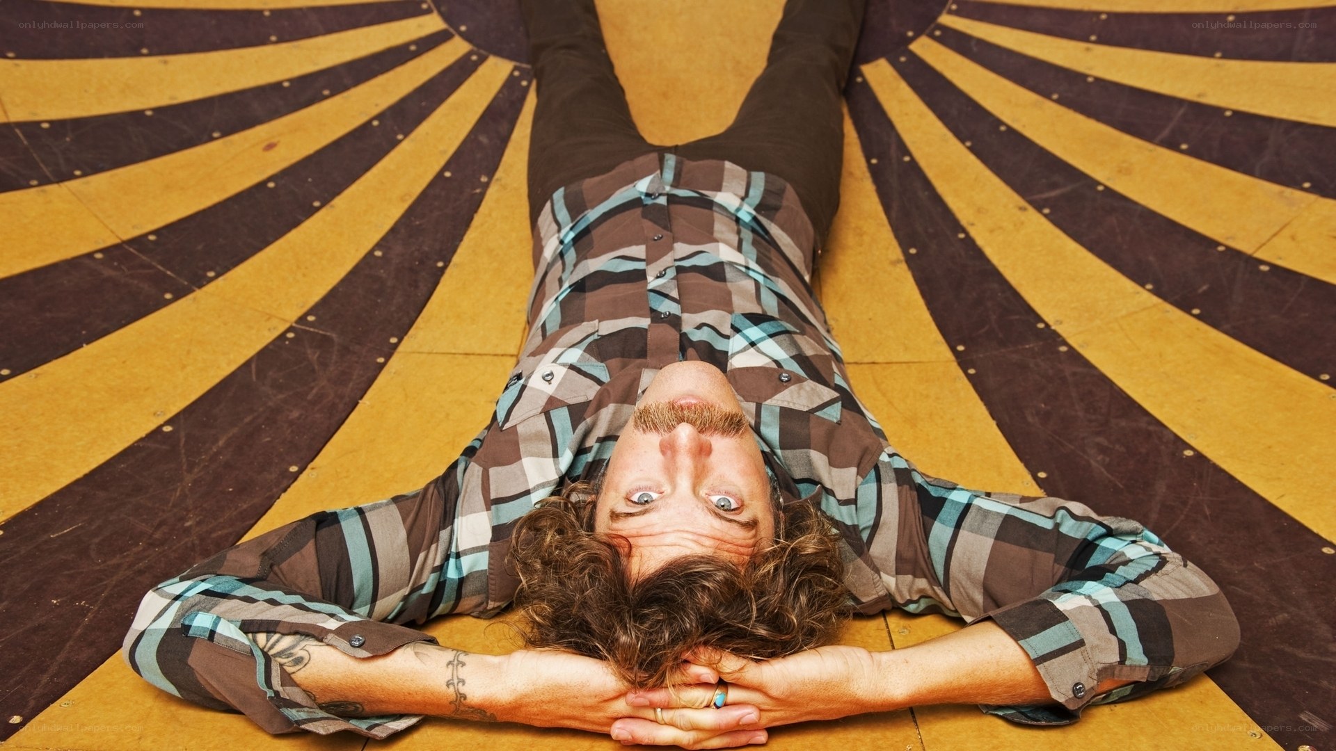 man lying on patterned floor
