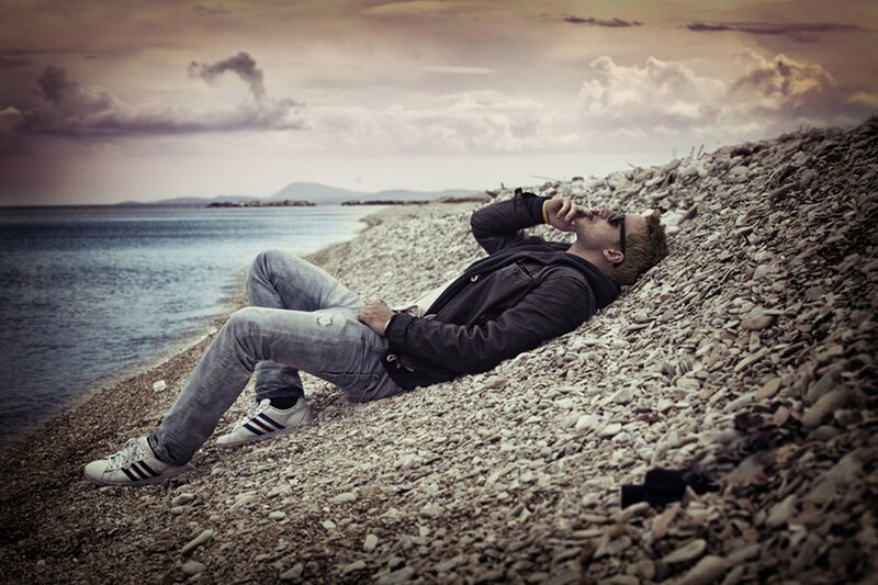 Man Lying on Pebble Beach