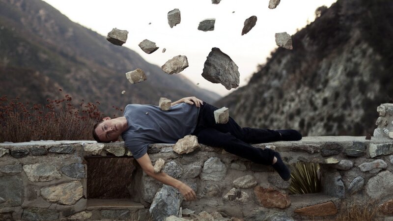 Man Lying on Stone Wall
