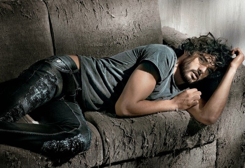 Man Lying on Torn Couch — Gray