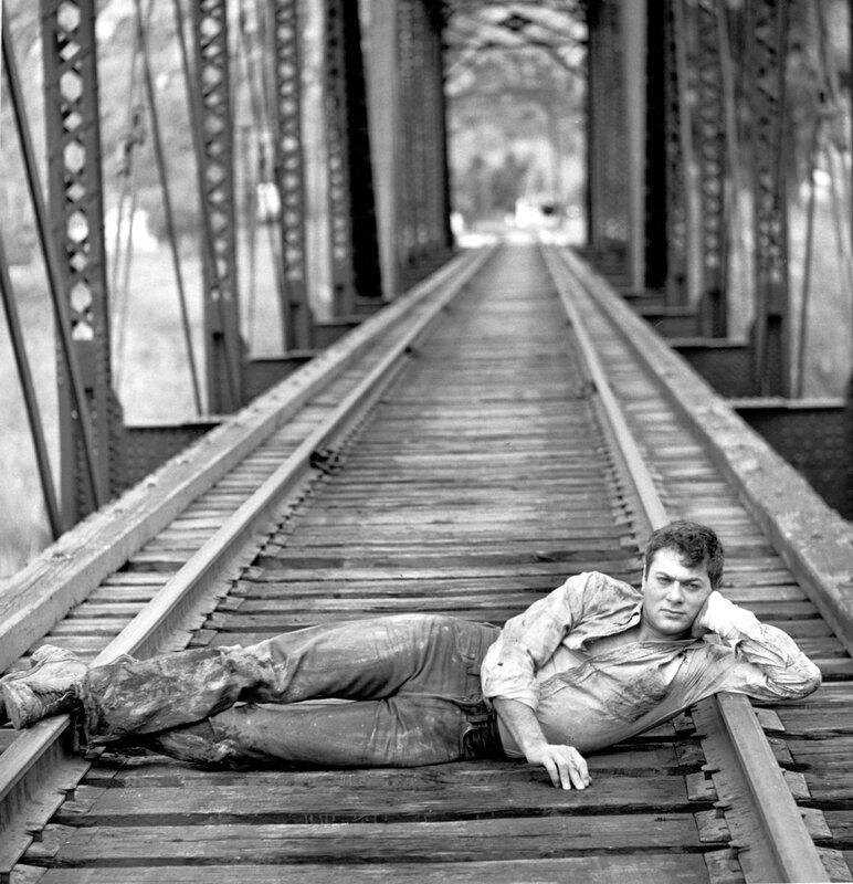 man lying on train tracks