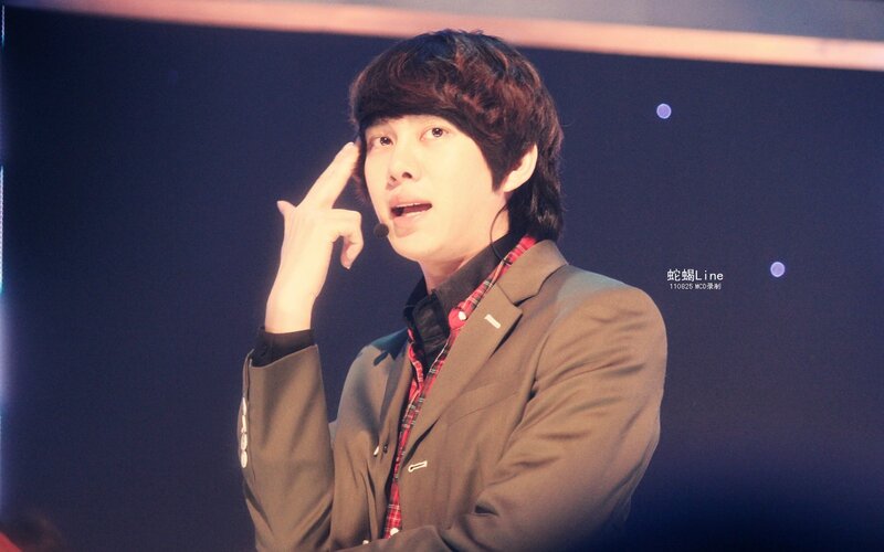 man making hand gesture on stage