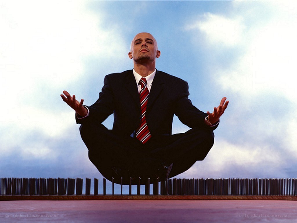 man meditating in suit