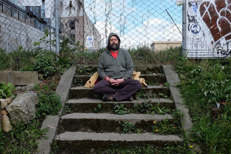 Man meditating on steps