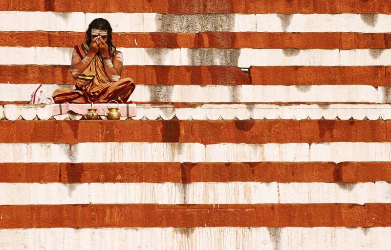 Man Meditating on Steps — Red