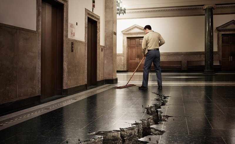 Man mopping a cracked floor