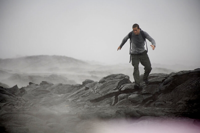 man navigating volcanic terrain