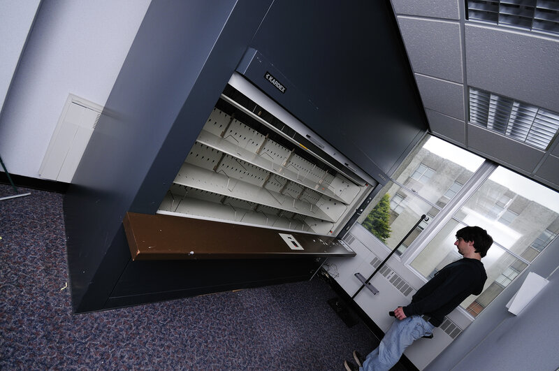 man near a bookshelf machine