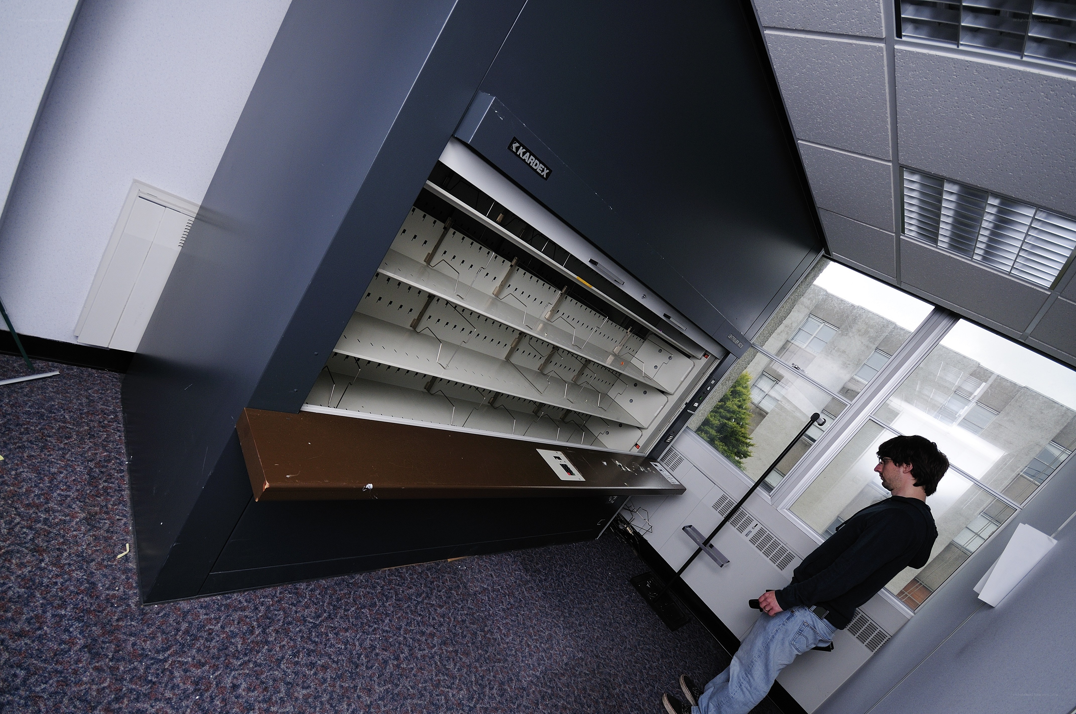 man near a bookshelf machine