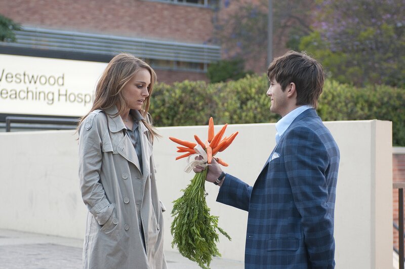 Man offers carrots to woman
