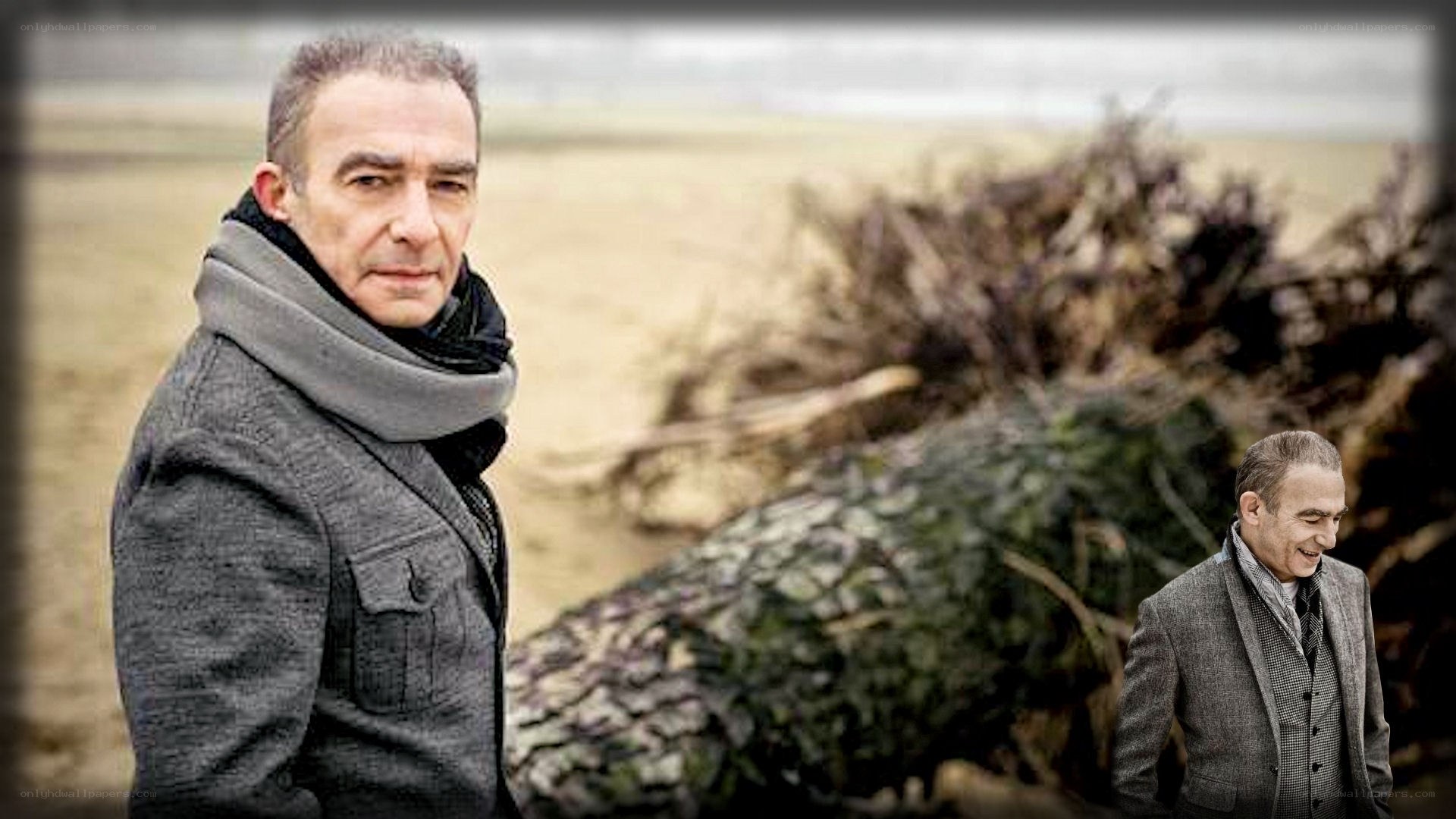 man on a beach with driftwood