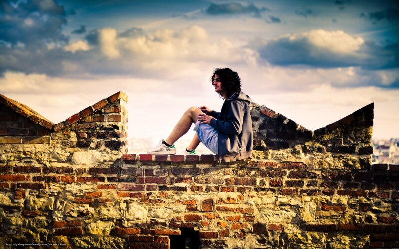 Man on a brick wall