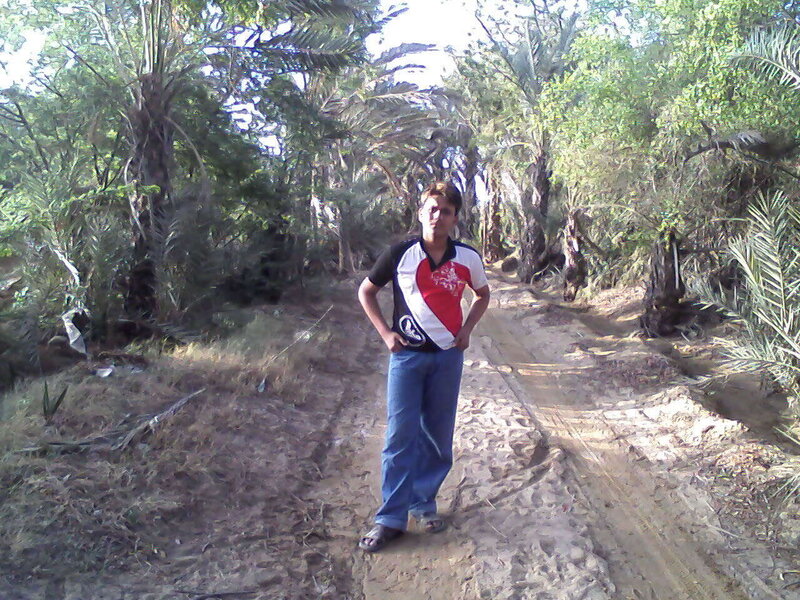 Man on a dirt path in a grove