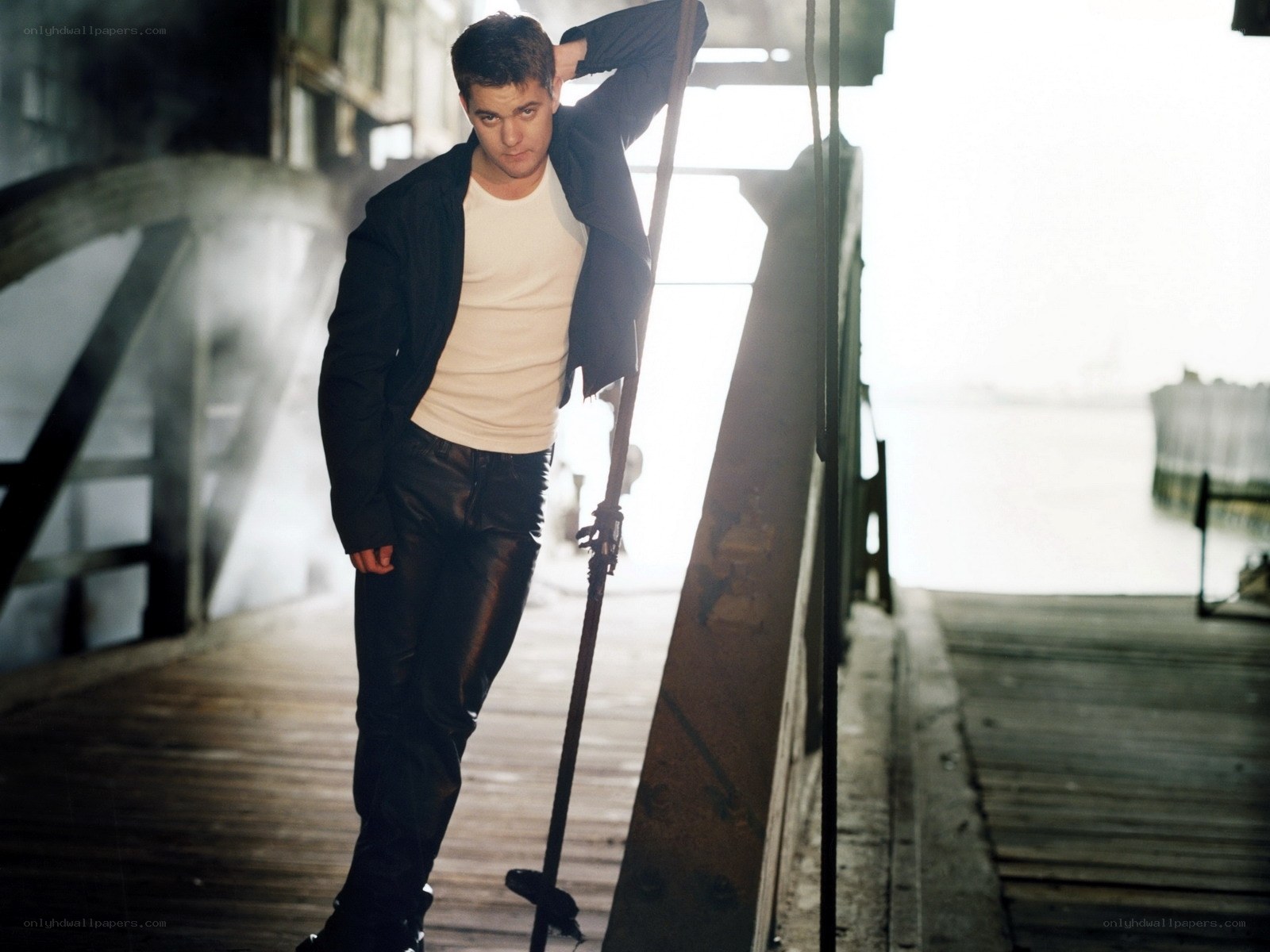 man on a dock with a pole