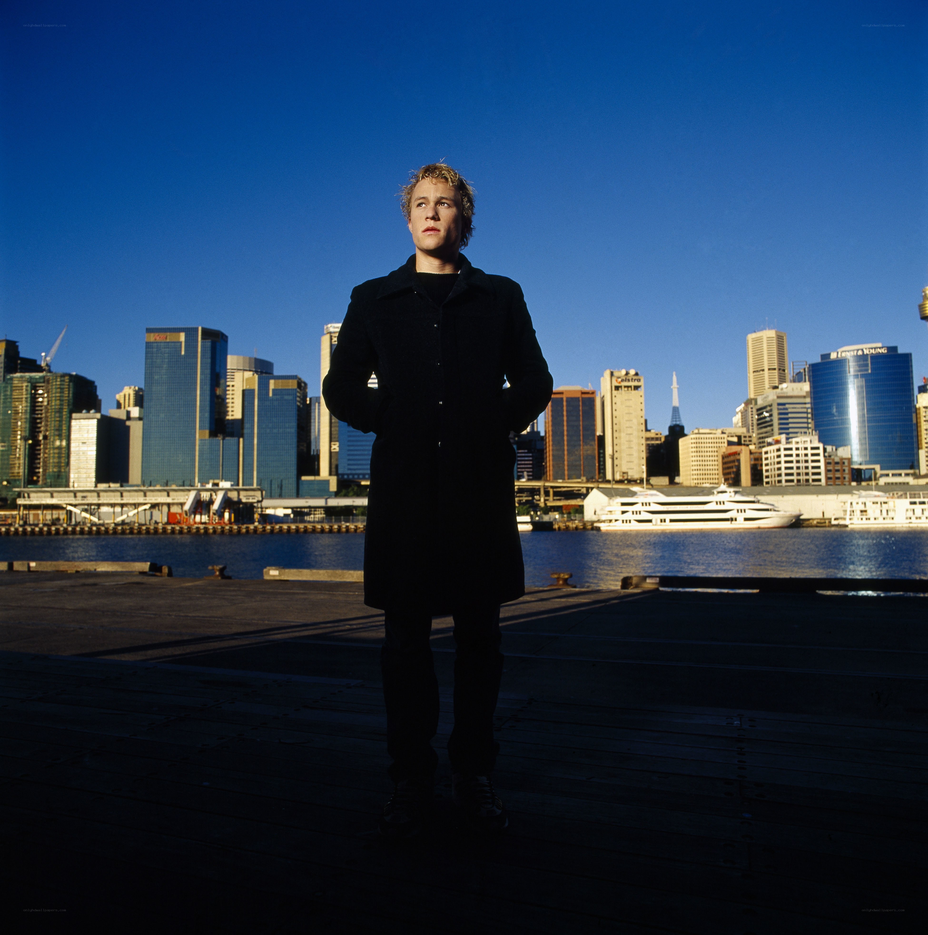 Man on a dock with city skyline