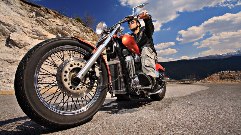 Man on a motorcycle in the mountains