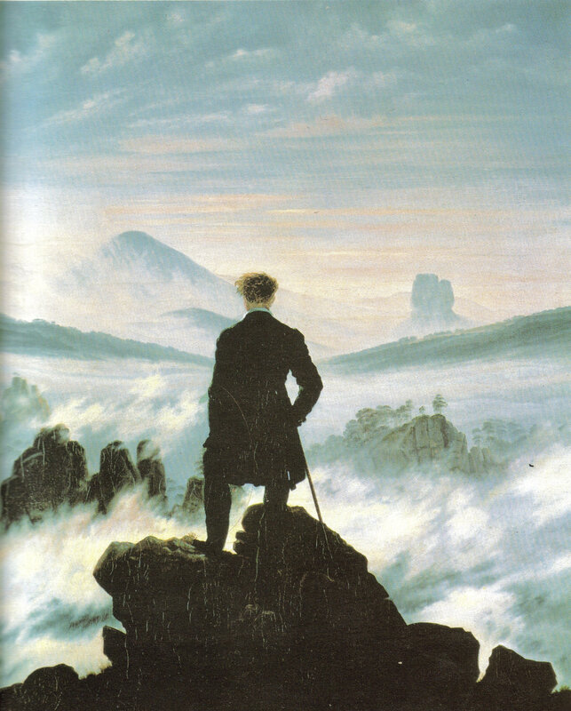 Man on a mountain overlooking mist