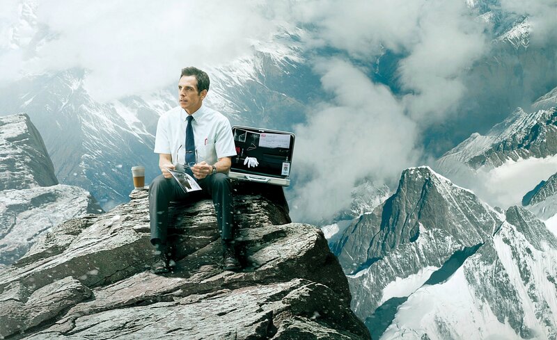 Man on a mountain with briefcase