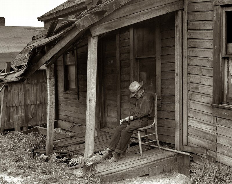 Man on a porch in old house