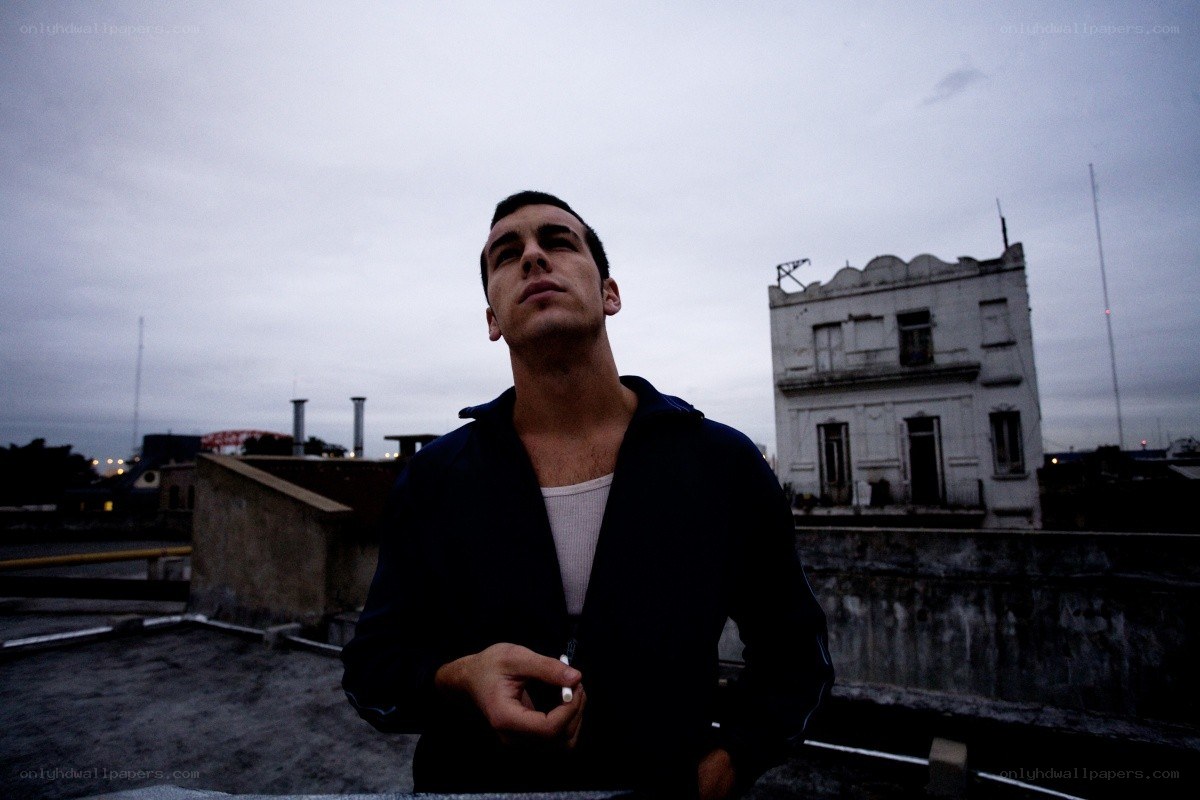 man on a rooftop at dusk