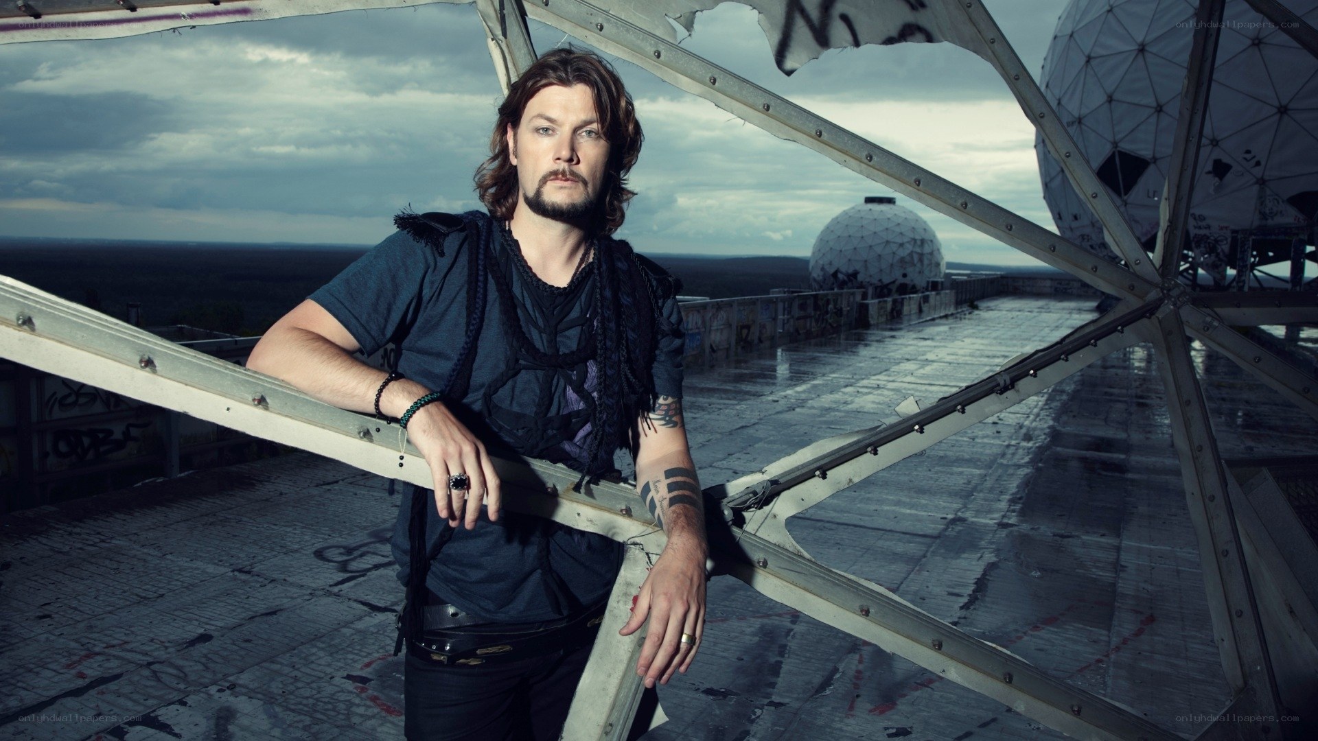 man on a rooftop with satellite dishes