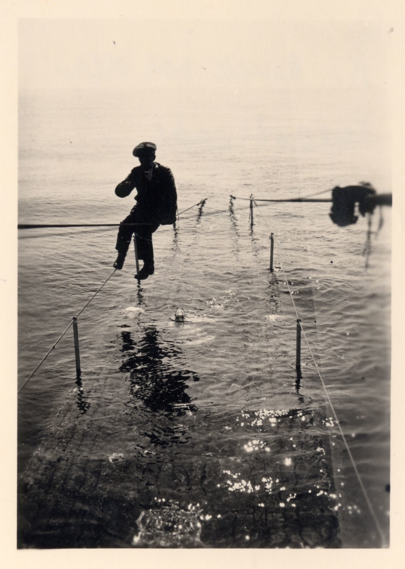 Man on a tightrope over water