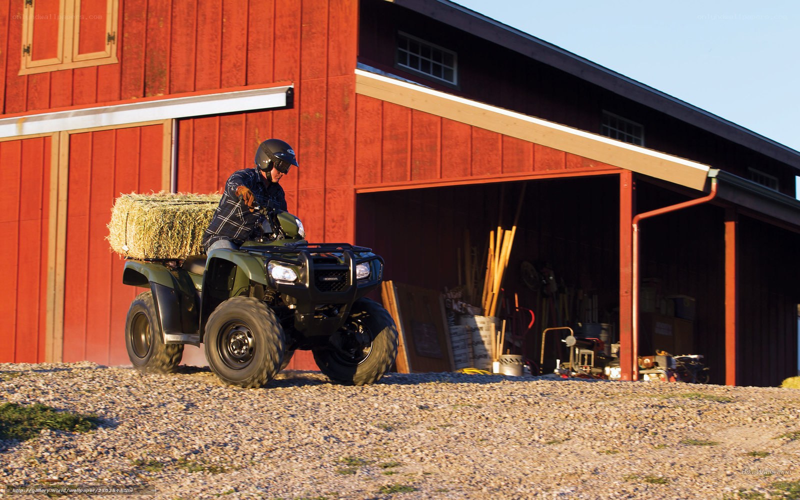 Man on ATV with hay bale