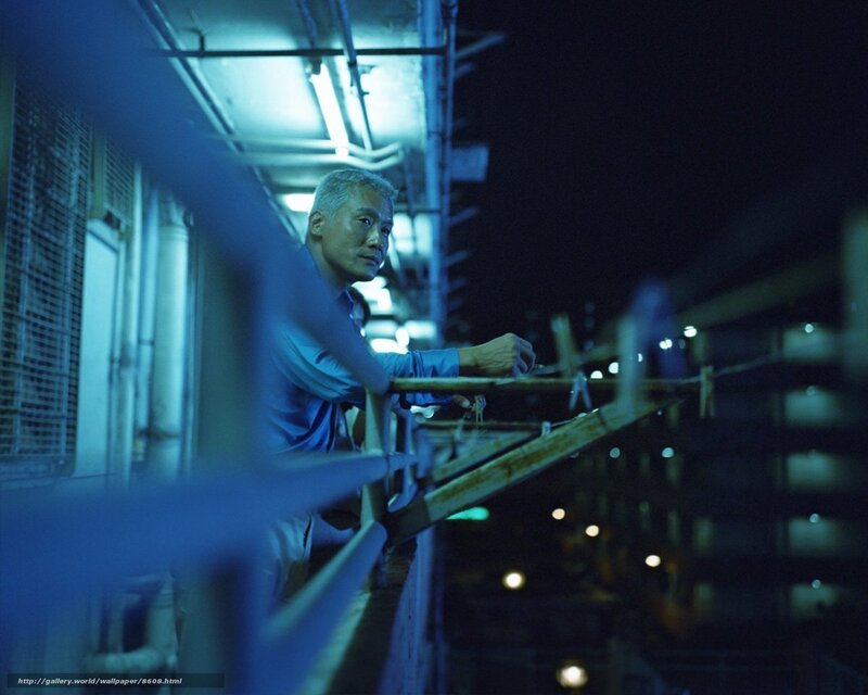 Man on balcony at night