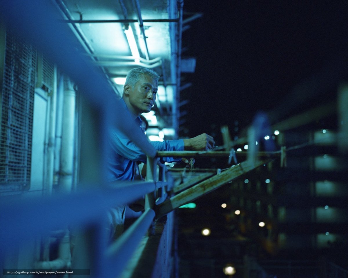Man on balcony at night