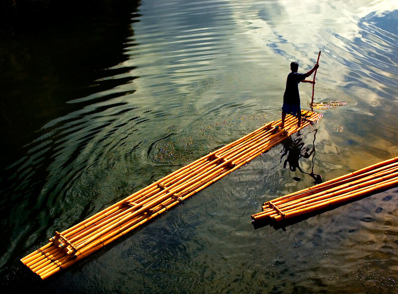 Man on bamboo raft