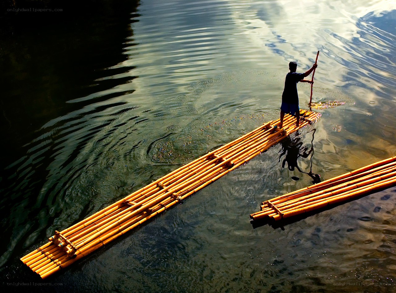Man on bamboo raft