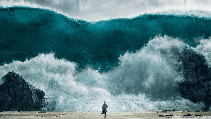 Man on Beach Facing Wave
