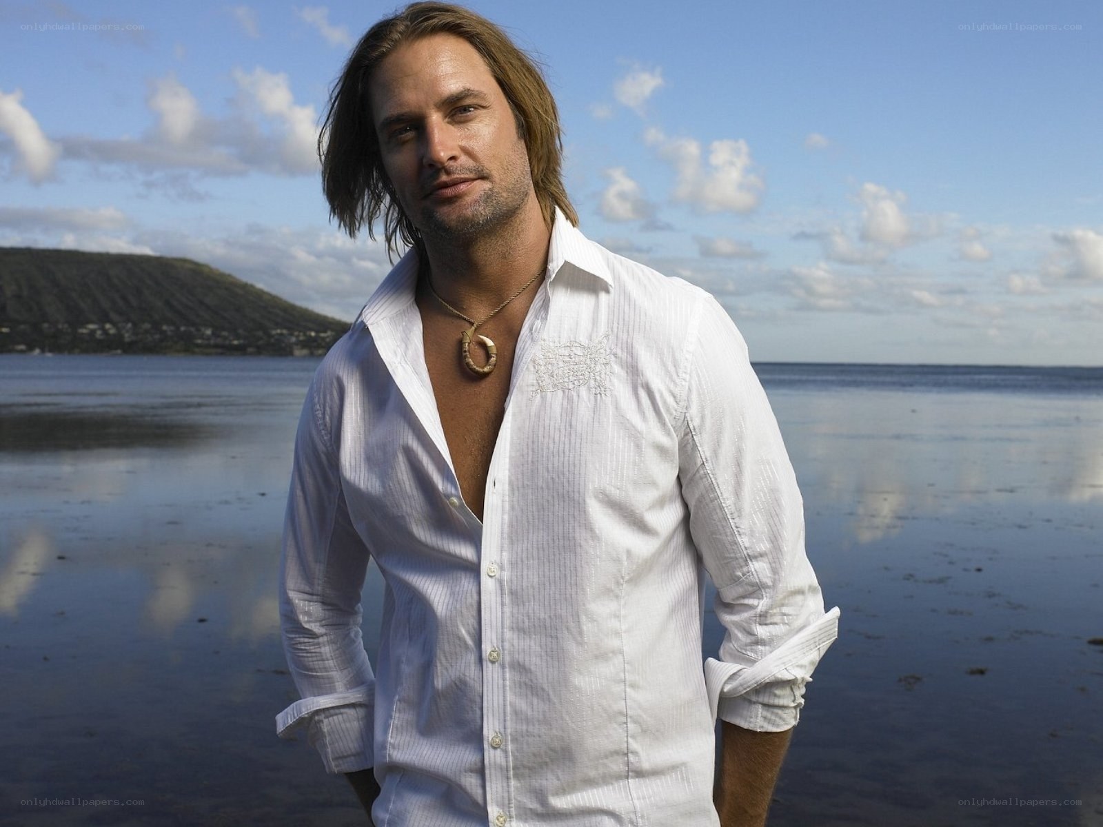 Man on beach in white shirt