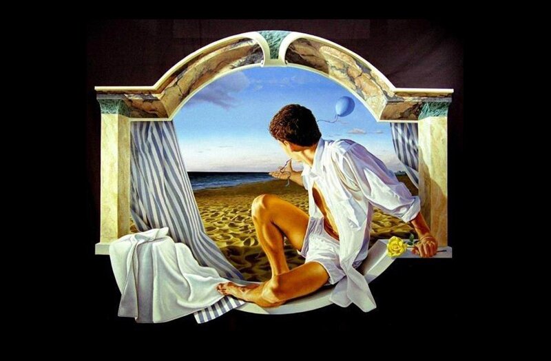 man on beach through arch
