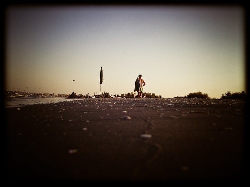 Man on Beach with Surfboard