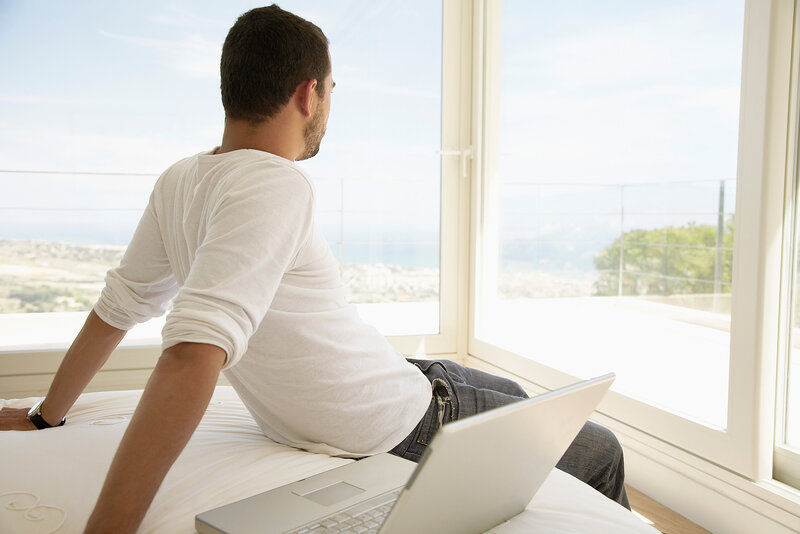 Man on Bed with Laptop
