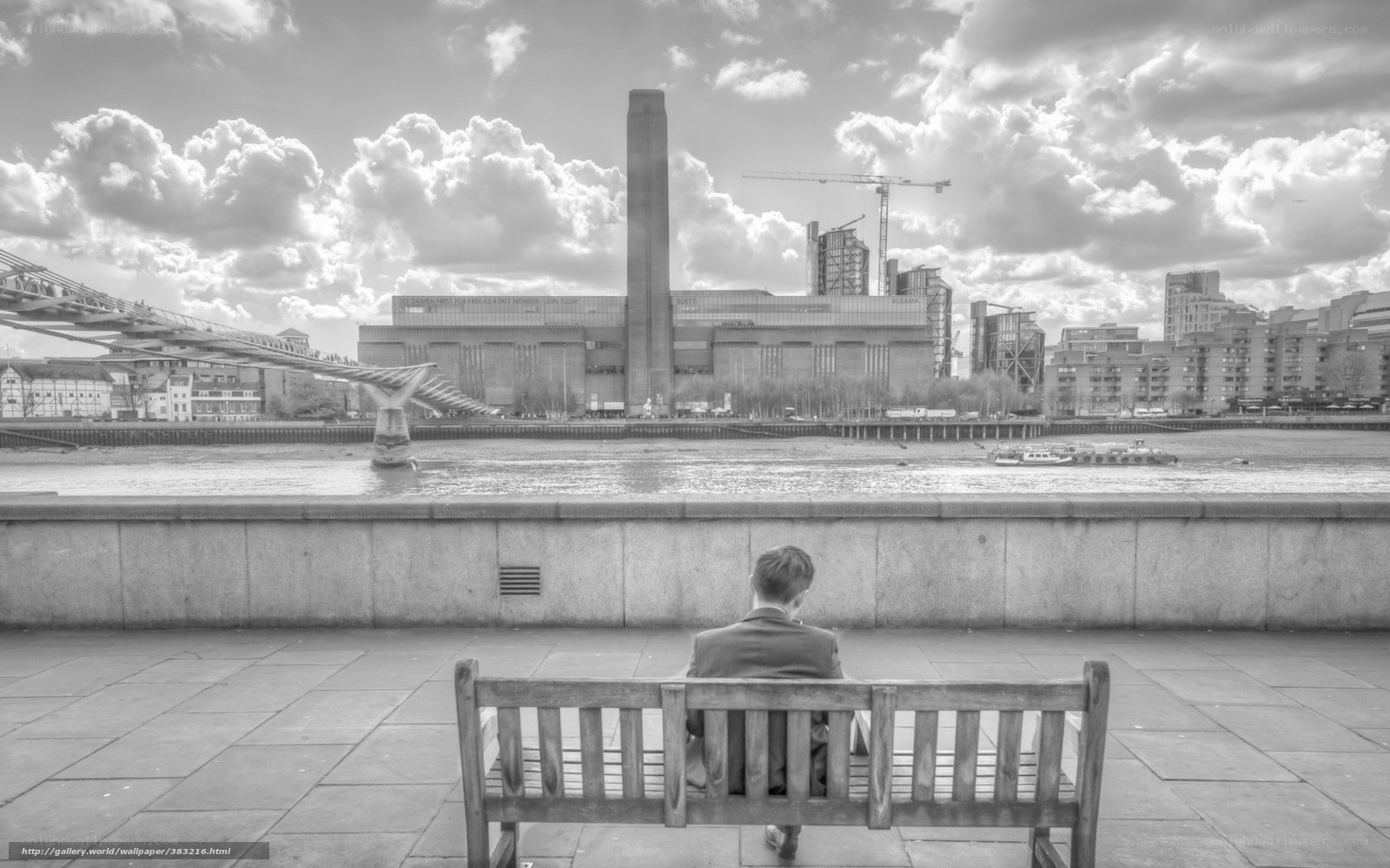 Man on bench by river