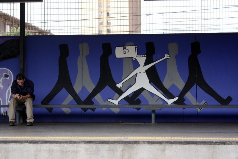 Man on bench with mural
