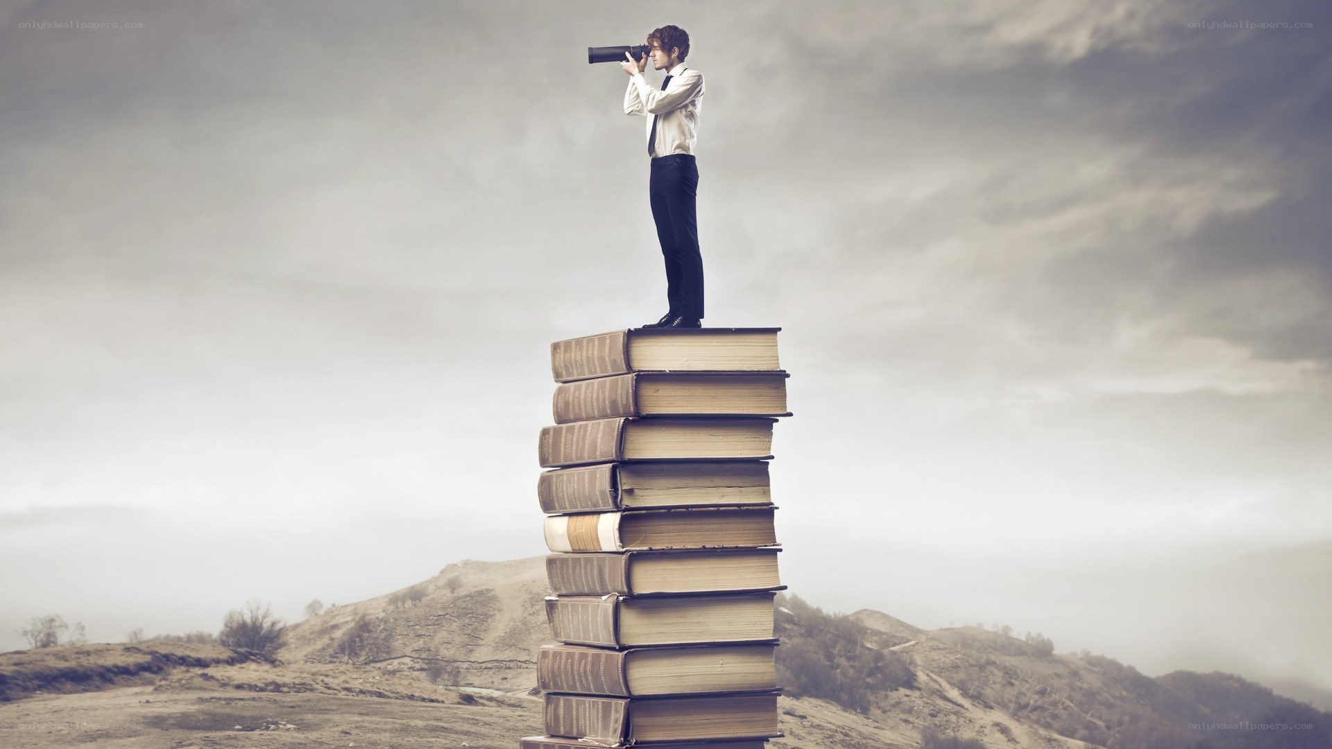 man on books with binoculars