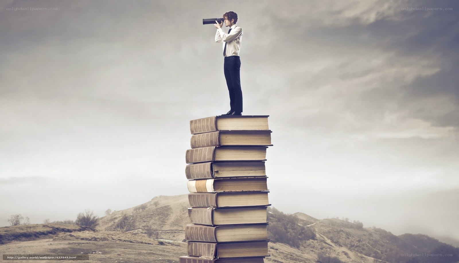 man on books with binoculars