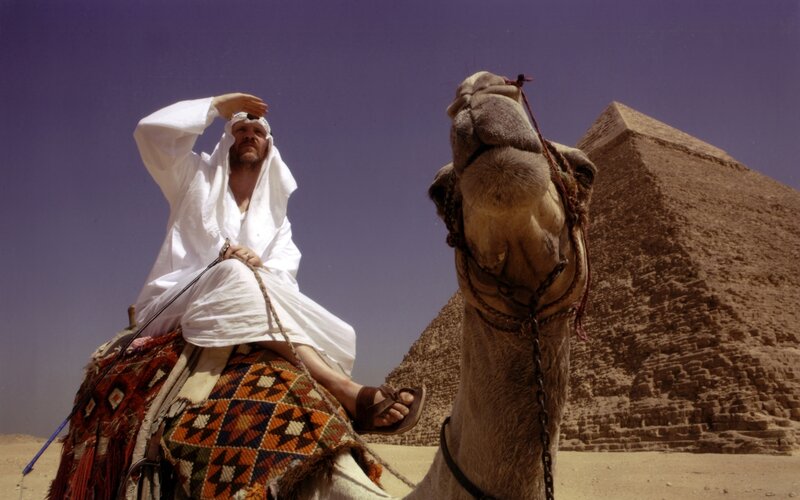 Man on camel near pyramid