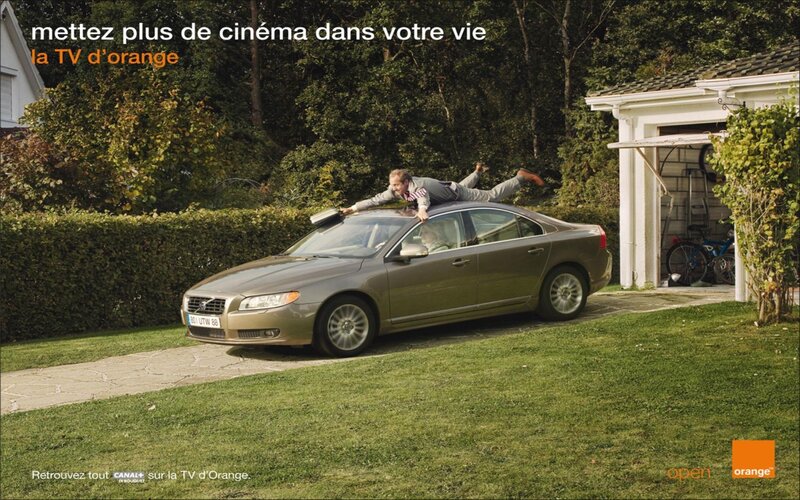 man on car roof ad
