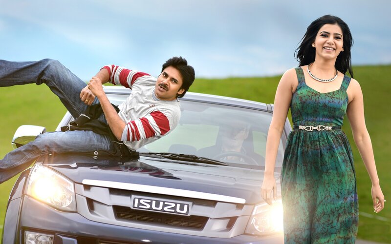 Man on car with woman standing